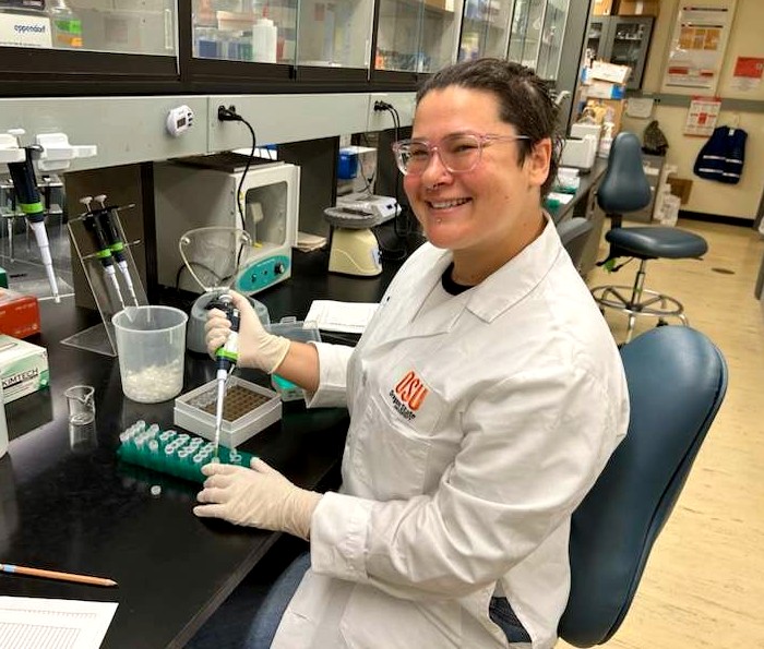 Photo of Heather pipetting in the lab