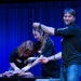 Taylor Chapple educates audience members about shark reproduction while holding the reproductive organs of a salmon shark being dissected by Reilly Boyt (left) and Maddie English (middle) during Big Fish Fest. Photo: Carter Pardue / Daily Barometer