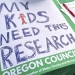 sign reading, My Kids Need this Reseach. photo: Tiffany Camhi / OPB